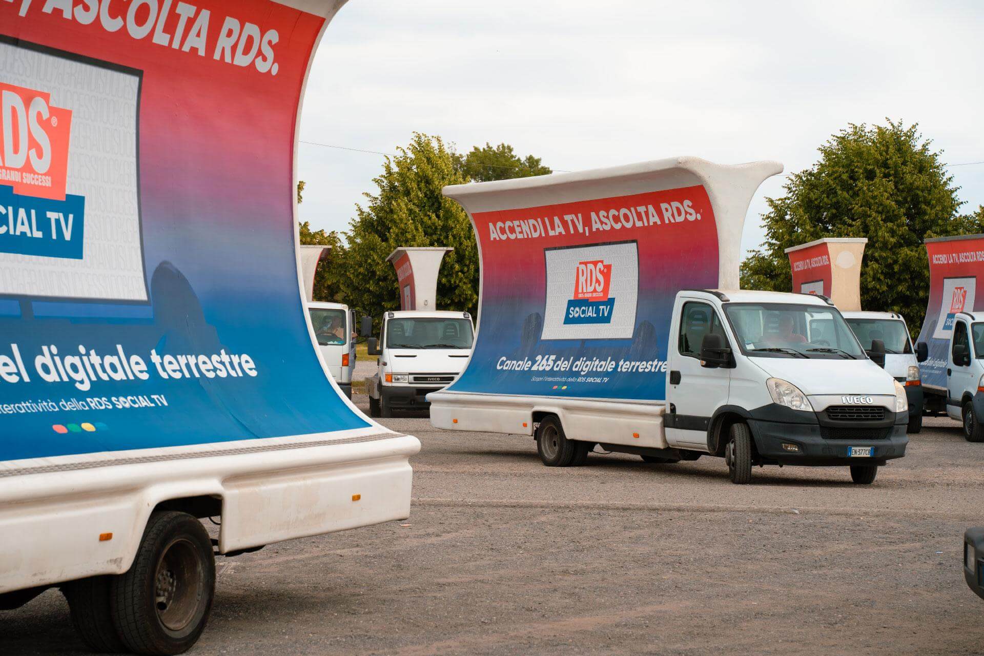 Flotta di camion vela RDS con campagna Accendi la TV Ascolta RDS in un piazzale